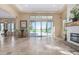 Living room with fireplace and large sliding doors leading to the backyard at 16401 W Monterey Way, Goodyear, AZ 85395