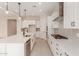 Modern kitchen with white cabinets, quartz countertops, and stainless steel appliances at 23964 N 171St Ln, Surprise, AZ 85387