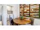 Bright dining area with wooden table and chairs, adjacent to laundry at 7577 W Darrow St, Laveen, AZ 85339