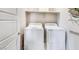 Laundry room with washer and dryer, built-in shelving at 7577 W Darrow St, Laveen, AZ 85339
