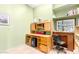 Home office with built-in wooden desk and shelving at 6347 E Old West Way, Cave Creek, AZ 85331