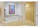 Spa-like bathroom with soaking tub and walk-in shower at 15802 N 71St St # 307, Scottsdale, AZ 85254