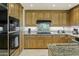 Modern kitchen with granite countertops and stainless steel appliances at 15802 N 71St St # 307, Scottsdale, AZ 85254