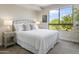 Bright bedroom with golf course views and nightstands at 15802 N 71St St # 307, Scottsdale, AZ 85254