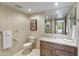 Modern bathroom with a vanity, toilet, and large mirror at 15802 N 71St St # 307, Scottsdale, AZ 85254