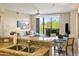 Granite kitchen island with breakfast bar and adjacent dining area at 15802 N 71St St # 307, Scottsdale, AZ 85254