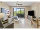 Bright living room with modern furniture and balcony access at 15802 N 71St St # 307, Scottsdale, AZ 85254