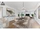 Elegant dining room with modern light fixture and views to the living room at 5525 E Dusty Wren Dr, Cave Creek, AZ 85331