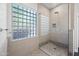 Bathroom with glass shower, tile flooring, and a large block window at 5525 E Dusty Wren Dr, Cave Creek, AZ 85331