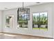 Bright dining room with hardwood floors, large windows, and modern light fixture at 5525 E Dusty Wren Dr, Cave Creek, AZ 85331