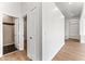Hallway with light walls, wood-look tile floor, and access to bathroom at 5525 E Dusty Wren Dr, Cave Creek, AZ 85331