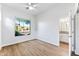 Spacious bedroom with large window and wood-look tile flooring at 5525 E Dusty Wren Dr, Cave Creek, AZ 85331
