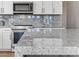 Granite countertop kitchen island with modern range at 5525 E Dusty Wren Dr, Cave Creek, AZ 85331