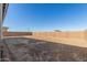 Spacious backyard enclosed by a brick wall and ready for customization at 21680 E Roundup Way, Queen Creek, AZ 85142