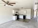 Open kitchen with white cabinets and dark appliances at 137 E Douglas Ave, Coolidge, AZ 85128