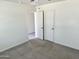 Spacious bedroom with neutral carpet and double doors at 137 E Douglas Ave, Coolidge, AZ 85128