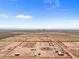 Aerial view of a large equestrian property with a riding arena and paddocks at 48940 W Long Rifle Rd, Aguila, AZ 85320
