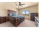 Spacious bedroom with a large bed, dresser, and window offering a view at 48940 W Long Rifle Rd, Aguila, AZ 85320