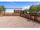 One-story home with a rustic wooden fence and gated entryway at 48940 W Long Rifle Rd, Aguila, AZ 85320