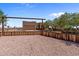 One-story home with a rustic wooden fence and gated entryway at 48940 W Long Rifle Rd, Aguila, AZ 85320