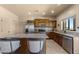 Modern kitchen with granite countertops, stainless steel appliances, and wood cabinetry at 48940 W Long Rifle Rd, Aguila, AZ 85320