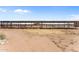 Row of covered horse stables with metal fencing at 48940 W Long Rifle Rd, Aguila, AZ 85320