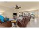 Spacious living room with leather recliners, a large TV, and a cowhide rug at 48940 W Long Rifle Rd, Aguila, AZ 85320