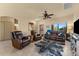 Open concept living area with leather seating, a TV and view into the dining area at 48940 W Long Rifle Rd, Aguila, AZ 85320