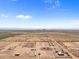 Aerial view of a large property with a house, stables, and riding arena at 48940 W Long Rifle Rd, Aguila, AZ 85320
