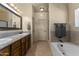 Bathroom with granite double vanity, large mirror, and bathtub at 48940 W Long Rifle Rd, Aguila, AZ 85320