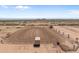 Aerial view of a well-maintained riding arena within a large property at 48940 W Long Rifle Rd, Aguila, AZ 85320