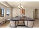 Bright dining area with chandelier and rustic wooden table at 48940 W Long Rifle Rd, Aguila, AZ 85320