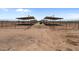 Multiple covered stables offering ample space for horses at 48940 W Long Rifle Rd, Aguila, AZ 85320