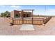 One-story home with wooden fence and gate, showcasing southwestern style at 48940 W Long Rifle Rd, Aguila, AZ 85320
