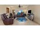 Relaxing living room featuring leather furniture, a TV, and southwestern decor at 48940 W Long Rifle Rd, Aguila, AZ 85320