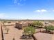 Aerial view of a ranch house with a large yard and desert surroundings at 48940 W Long Rifle Rd, Aguila, AZ 85320