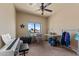 Bedroom with piano, desk, and ample closet space at 48940 W Long Rifle Rd, Aguila, AZ 85320