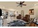 Living room with leather furniture, a large TV and view into kitchen and dining area at 48940 W Long Rifle Rd, Aguila, AZ 85320