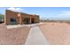 Backyard patio with a bench and walkway at 48940 W Long Rifle Rd, Aguila, AZ 85320