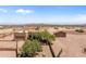 Aerial view of a ranch-style home with a detached garage and expansive desert landscape at 48940 W Long Rifle Rd, Aguila, AZ 85320