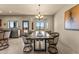 Open concept dining area with large windows and rustic decor at 48940 W Long Rifle Rd, Aguila, AZ 85320