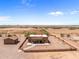 Aerial view of a ranch-style home with a detached workshop and spacious yard at 48940 W Long Rifle Rd, Aguila, AZ 85320