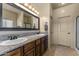 Bathroom boasts granite double vanity, large mirror, and shower at 48940 W Long Rifle Rd, Aguila, AZ 85320