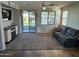 Cozy living room featuring a comfy couch and sliding glass door leading to backyard at 18235 N Calacera St, Maricopa, AZ 85138