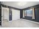 Bedroom with dark walls, white closet doors, and large window at 5599 S Alameda Rd, Gold Canyon, AZ 85118