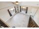 Upstairs loft area with tile flooring, two windows, and a staircase at 5599 S Alameda Rd, Gold Canyon, AZ 85118