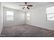 Spacious bedroom with neutral carpeting and multiple windows at 19778 W Monroe St, Buckeye, AZ 85326