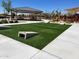 Community area with cornhole and a shaded seating area at 15963 W Montana De Oro Dr, Surprise, AZ 85387