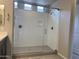 Walk-in shower with glass enclosure and built-in bench at 15963 W Montana De Oro Dr, Surprise, AZ 85387