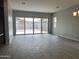 Living area with sliding glass doors and view of backyard at 15963 W Montana De Oro Dr, Surprise, AZ 85387